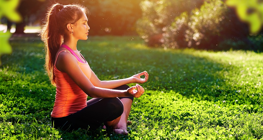 Yoga. Young woman practicing yoga or dancing or stretching in nature at park. Health lifestyle concept.