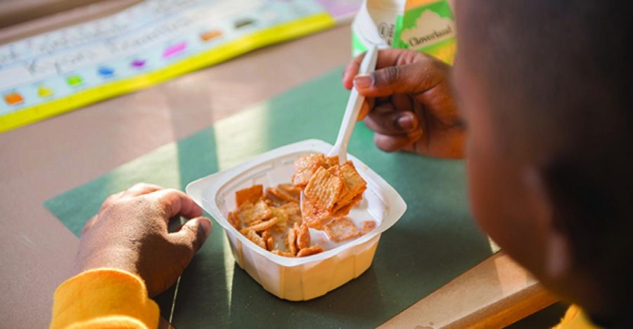 A child eats cereal during what is presumed to be breakfast